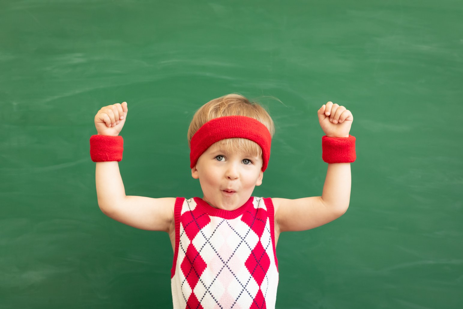 Happy Child Student against Green Chalkboard